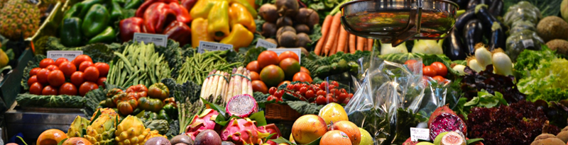 A market stall with an array of colourful vegetables and fruit on display