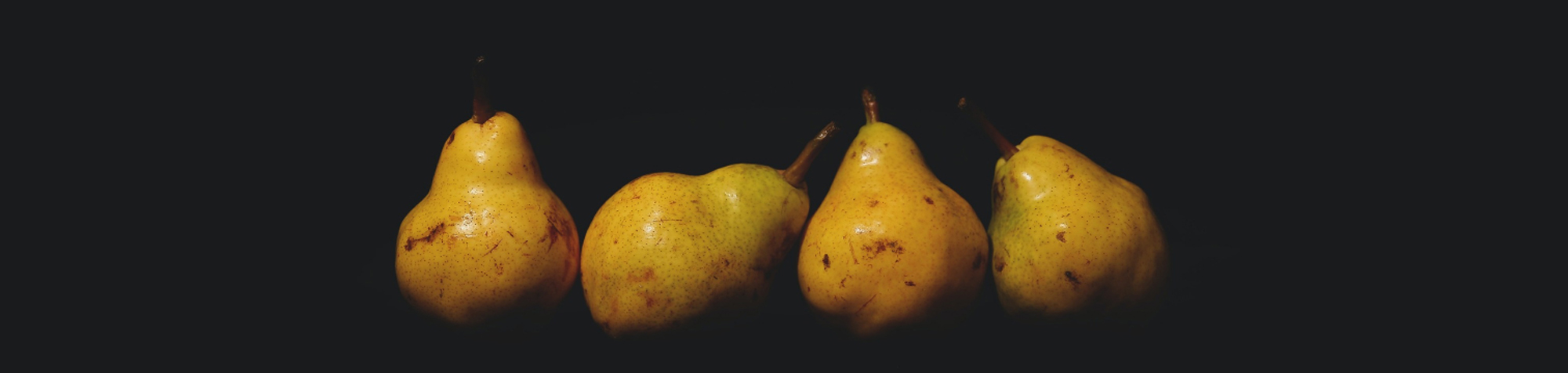 Opening image showing three golden pears with a dark background